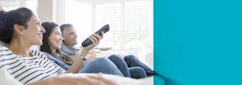 Family sitting while watching TV