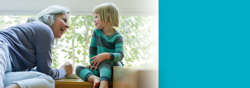 Woman smiling at child